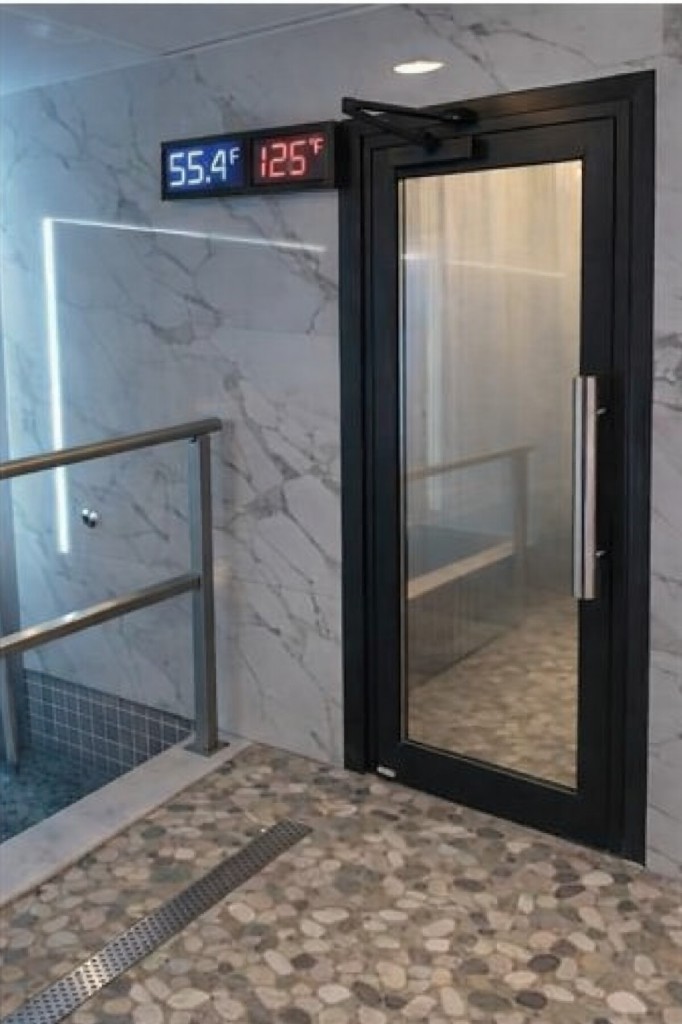 Cold plunge pool with blue tile finish and recessed design.